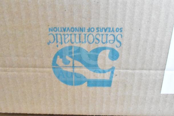Cardboard box with Sensormatic logo. Contains tier lot with Sensormatic ZBAMB9012 Label Deactivator Pad, computer keyboards.