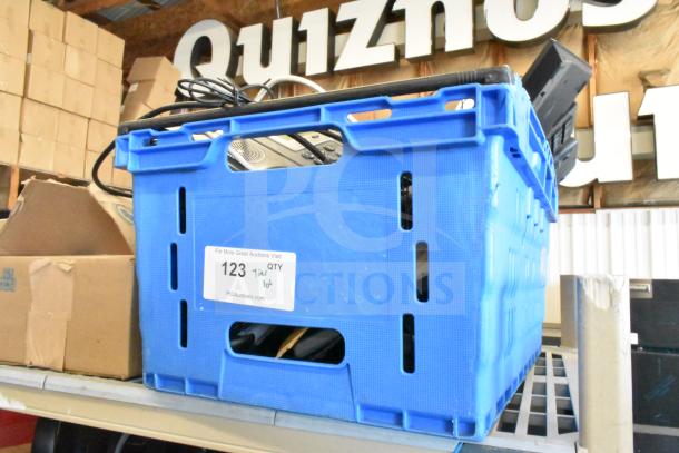 Blue plastic crate containing Sensormatic ZBAMB9012 Label Deactivator Pad and computer keyboards. Tag reads "123 Tier lot".