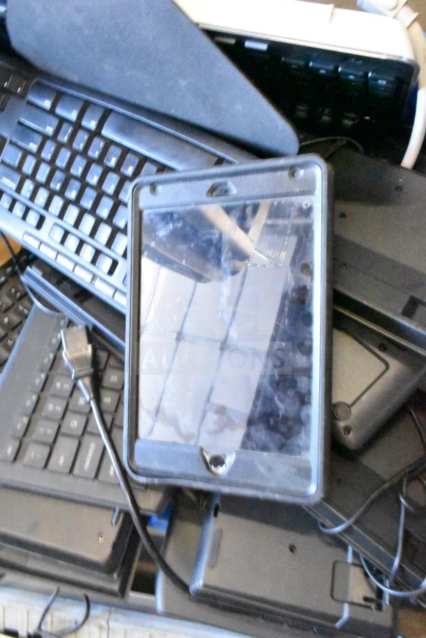 Tiered lot with Sensormatic ZBAMB9012 label deactivator pad and assorted computer keyboards; various conditions.