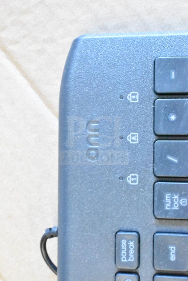 Computer keyboard close-up featuring keys and lock icons, part of an auction lot including Sensormatic ZBAMB9012 Deactivator Pad.