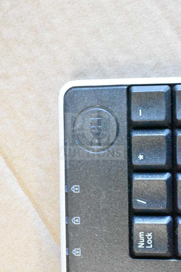 Dell keyboard partial view showing brand logo and Num Lock key.