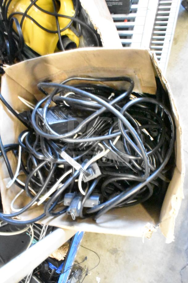 Lot of various items including HDMI splitter and cables in a box, some tangling visible, mixed condition.