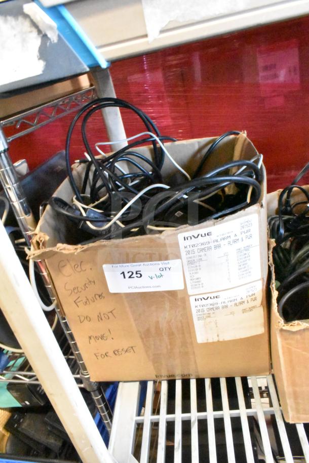 Box of various cables including HDMI splitter; labels indicate invue brand, 2015 camera bar, alarm & power. Condition mixed.