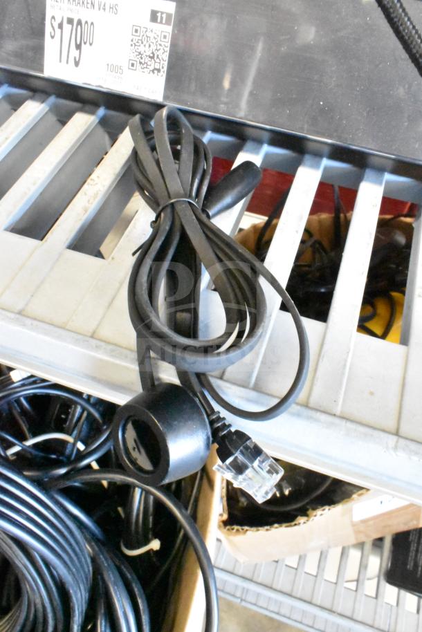 Lot of various items, including HDMI splitter and cables, in used condition on a metal shelf.