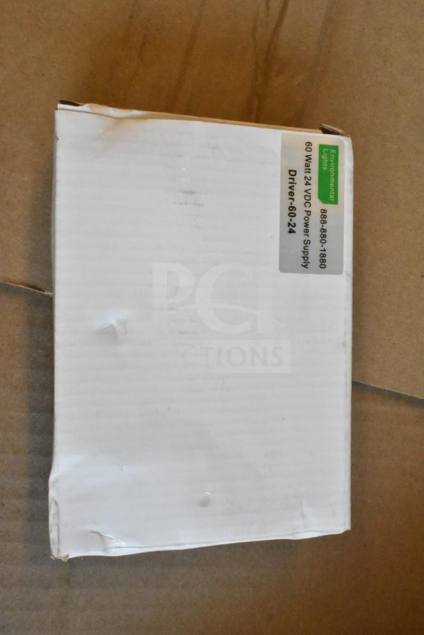 Box containing a 60 Watt 24 VDC power supply from Environmental Lights, with visible label. Box shows signs of wear.