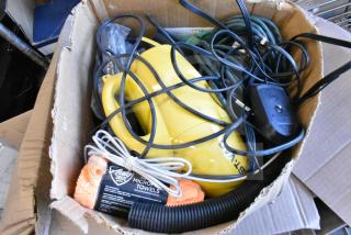 Lot of various items including a yellow Dust Vac, orange microfiber towel with "Auto Drive" label, and cords in a box.