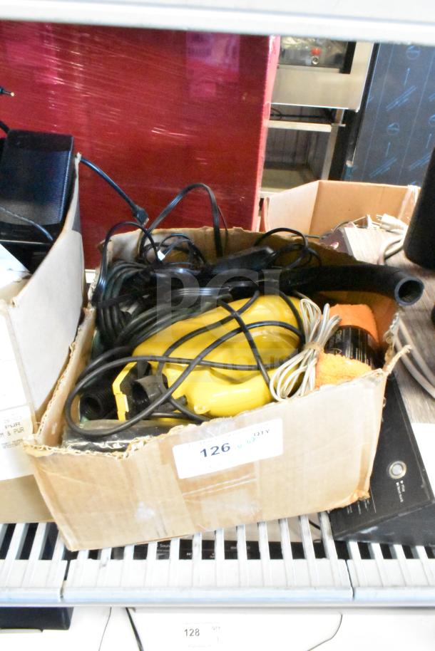Lot of various items in a box, including a yellow dust vac, microfiber towel, and cords. Condition appears used. Label reads "126 QTY".