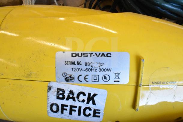 Yellow Dust-Vac with label showing specs: 120V-60Hz, 800W, CE and UL marks. Scratched condition with "BACK OFFICE" sticker.