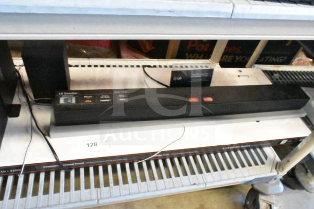 LG store display with sound bar and speaker, featuring control buttons and display features. Good condition. LG branding visible.