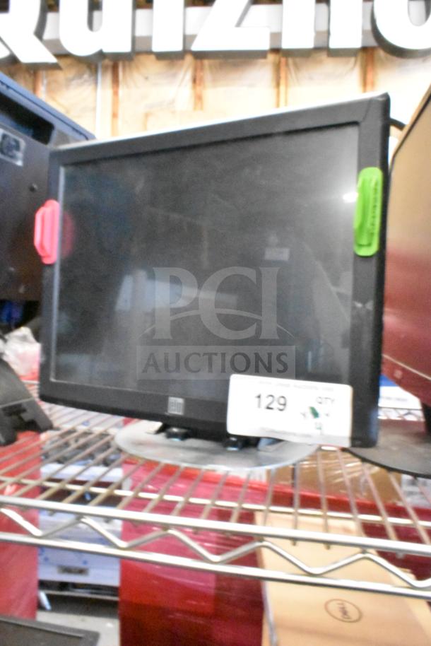 Four monitors: Costar, HP Compaq LE1711, Elo TouchSystems, Acer S240HL. Includes auction tag numbered 129. Condition appears used.