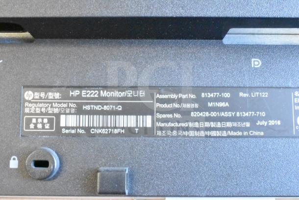Close-up of label on HP E222 monitor showing model HSTND-8071-Q, assembly part 813477-100, made July 2016, China.