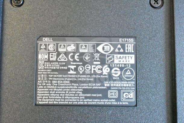Close-up of Dell E1715S monitor label showing safety certifications and manufacturer details.