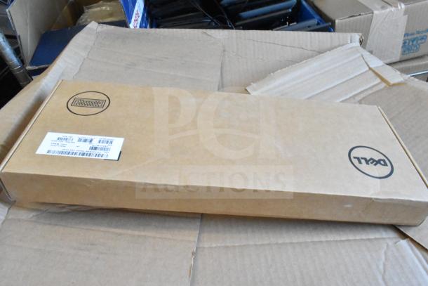 Cardboard box containing a Dell keyboard, unopened, visible label with product numbers. Part of a 9-item auction lot.