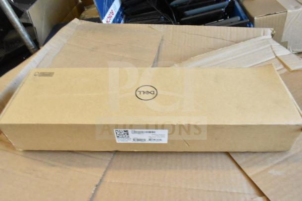 Cardboard box labeled with Dell logo, indicating a keyboard. Part of a lot of 9 items. New condition, auction set.