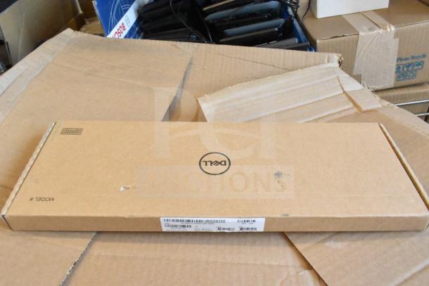 Cardboard box with Dell logo containing keyboard. Part of auction lot with 9 items. Box shows minor wear.