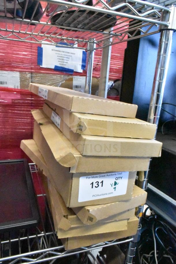 Nine assorted items, including a Dell keyboard, in sealed boxes on a metal shelf. Auction lot label reads "131, Qty 9."