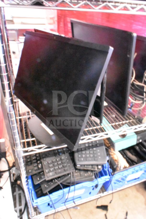 Five various monitors including HP, Onn ONA18HO015 21.5", Dell E2414Ht, IBM, displayed on metal shelf. Good condition.