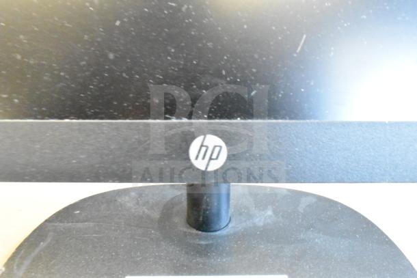 5 monitors including HP, Onn ONA18HO015 21.5", Dell E2414Ht, IBM. HP logo visible. Dusty condition.