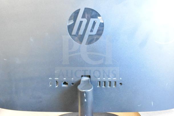 5 assorted monitors, brands include HP, Onn 21.5", Dell E2414Ht, IBM. Visible ports on HP monitor's back.