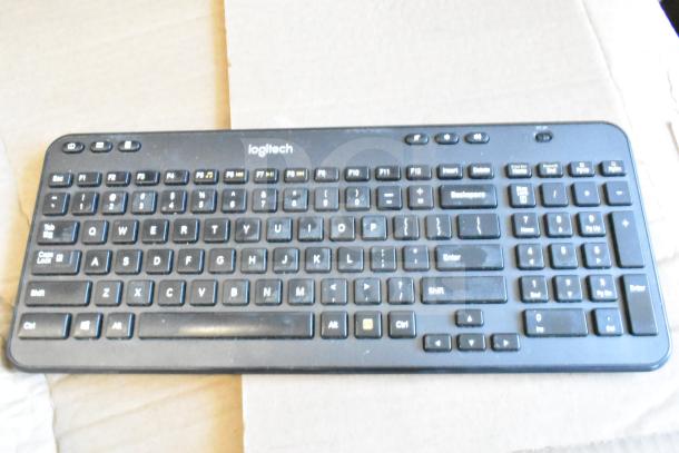 "Logitech wireless keyboard, black, QWERTY layout, with multimedia keys, lightly used, part of 40-keyboard auction lot."