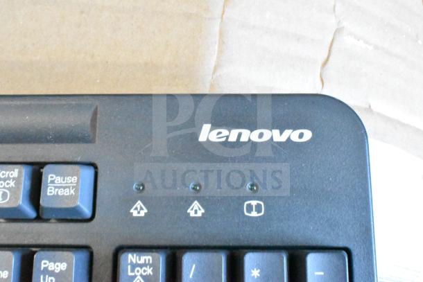 Lenovo computer keyboard, black, logo visible, includes indicator lights and function keys. Lot of 40 keyboards.