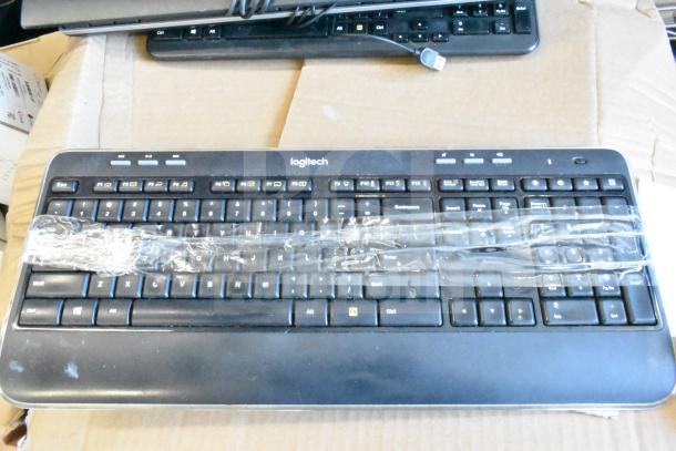 Lot of 40 Logitech computer keyboards, black, USB connectivity, wrapped for protection, good condition, bulk auction.