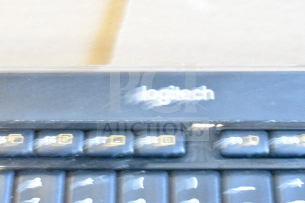 40 Logitech computer keyboards, bulk auction. Visible wear, functioning condition. Logitech branding on top panel.