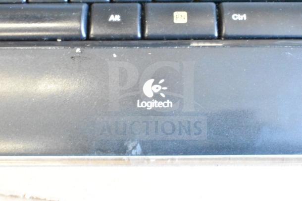 Lot of 40 items including Logitech keyboard and mouse. Visible wear, featuring Alt, FN, Ctrl keys. Logitech logo present.