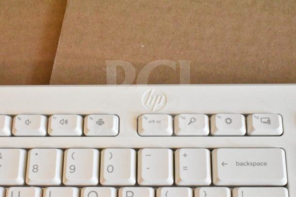 HP white computer keyboard in used condition. Visible function keys and HP logo. Part of a 40-item lot.