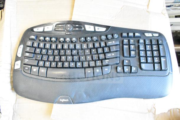 Logitech computer keyboard with multimedia keys, ergonomic design, visible wear, part of a 40-item tech auction lot.