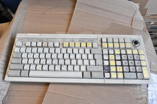 Vintage computer keyboard with white and yellow keys, custom labels. Good condition, worn from use. Part of 40-item auction lot.