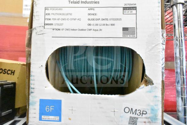 Box of Telaid Industries cable; labeled 6F OM3 indoor-outdoor CMP aqua jacket. Box ID: FBR-6F-OM3-IO-OFNP-AQ.