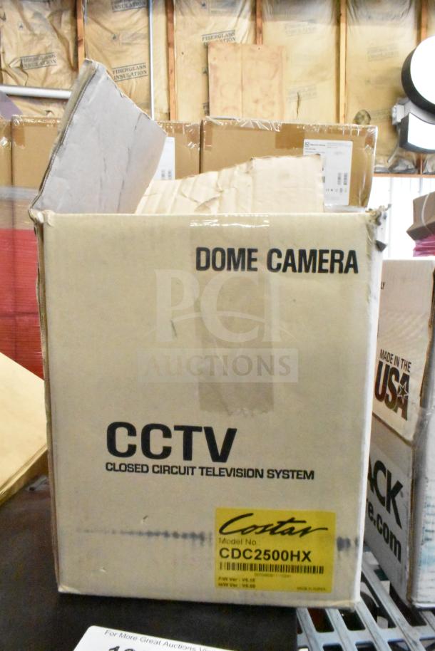 Box for Costar CCTV Dome Camera, model CDC2500HX. Box shows signs of wear. Contains various auction items.