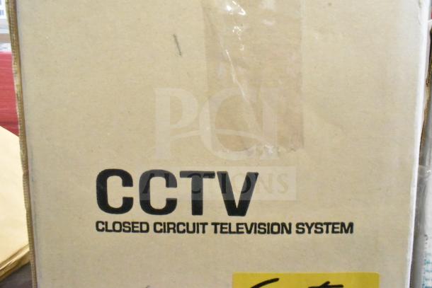 Cardboard box with "CCTV Closed Circuit Television System" text indicating a security camera system.