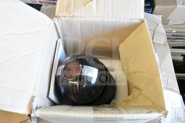 Box containing a CCTV dome camera, visible alongside Bosch packaging. Includes Dell tower, Wren Axis camera, other items.