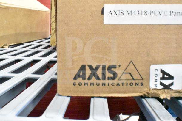 Cardboard box labeled "AXIS Communications" with marking "AXIS M4318-PLVE." Part of a 9-item auction lot.