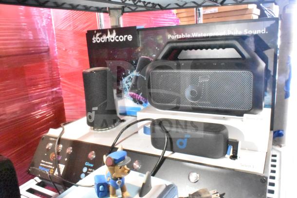 Soundcore store display with portable waterproof speakers and branding. Includes Boom 2 SE and Select 3 models.