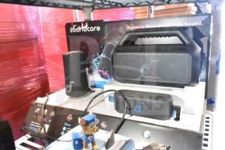 Soundcore store display with portable waterproof speakers and branding. Includes Boom 2 SE and Select 3 models.