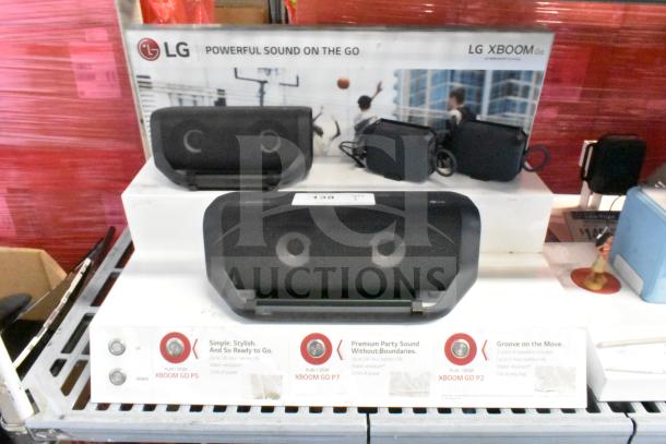 LG store display featuring LG Xboom speakers, showcasing model P5. Features include powerful sound, water resistance, and battery life details. Display includes promotional text and product images.