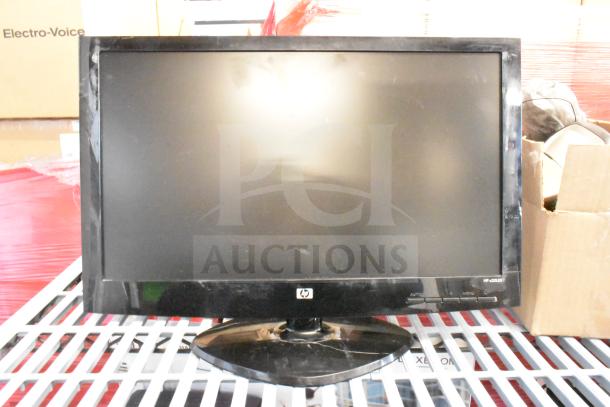 HP monitor, model HP w2007, in fair condition. Features include a black frame and stand. Includes 25 various monitors.