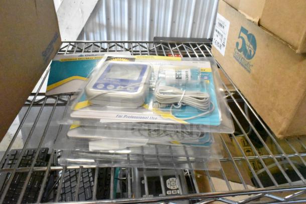 Three new DeltaTrak Min/Max Alarm Thermometers in packaging, with display screens and attached cables.