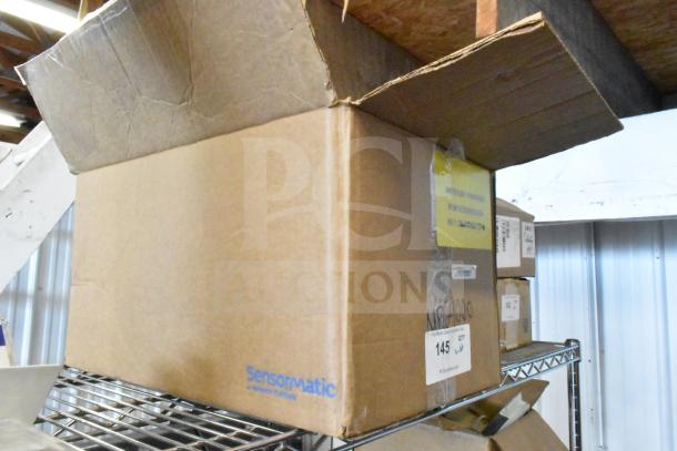Cardboard box of various items including Sensormatic ZBAMB9010-IPS Label Deactivator Controller, cables; in good condition.