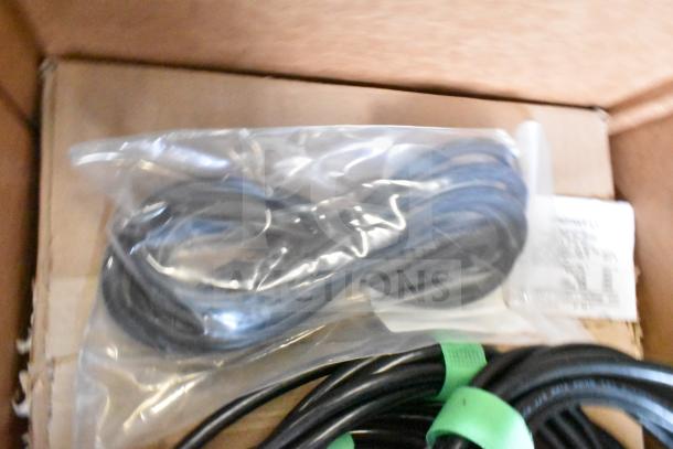 Lot of various items including Sensormatic ZBAMB9010-IPS label deactivator controller and cables. Items are packaged in bags.