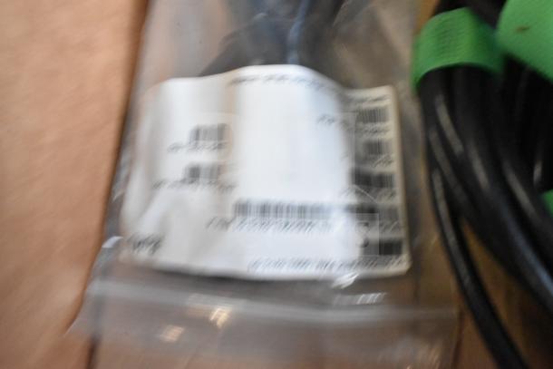 Lot includes Sensormatic ZBAMB9010-IPS label deactivator controller and cables. Labels show barcodes and text, slight blurring.