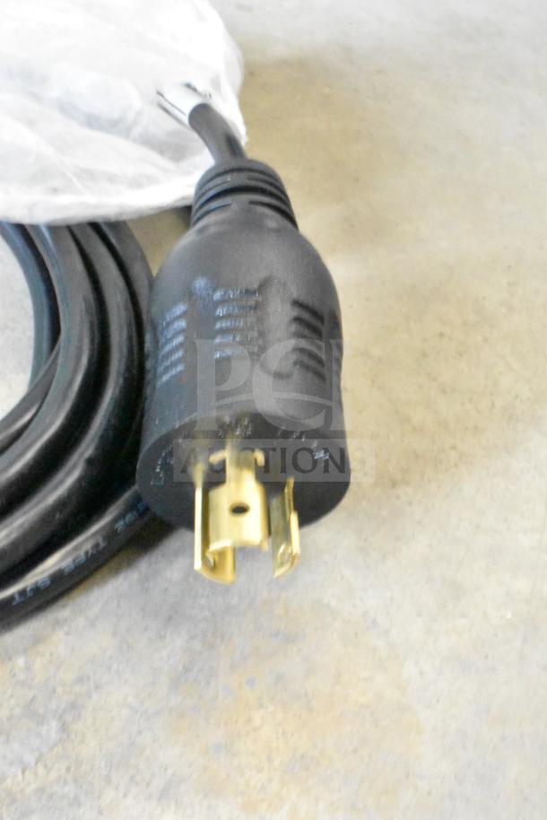 Black power cable with gold prongs, part of a lot including Sensormatic ZBAMB9010-IPS Label Deactivator Controller.