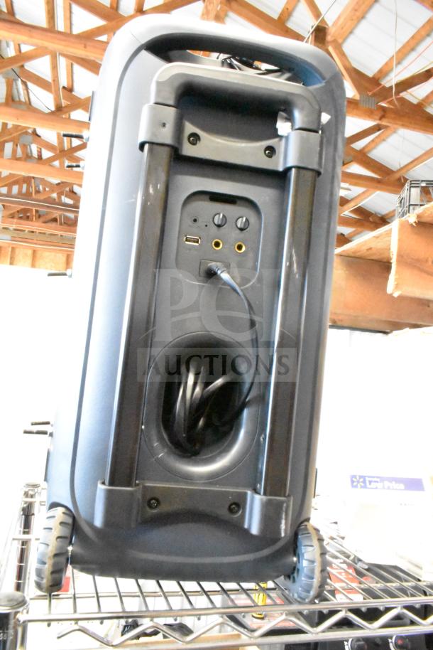 Portable speaker with wheels and handle. Features connectivity ports for USB and audio input. Good condition.