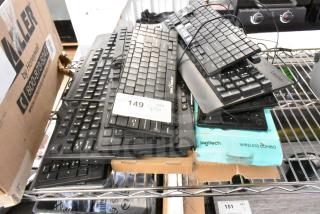 13 assorted computer keyboards, various brands including Logitech and Lenovo. Mixed wired and wireless models. Condition varies.