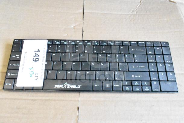 Seal Shield computer keyboard on cardboard, featuring a full layout. Tag labeled "149 QTY" visible.