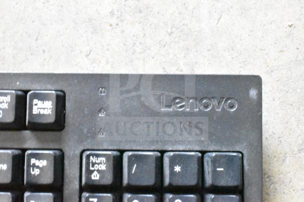 Lenovo keyboard corner close-up, showing keys and the brand logo. Part of 13 various computer keyboards auction lot.
