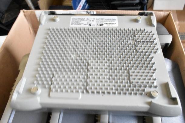 6 Sensormatic ZBAMB9010-IPS label deactivators in a box, gray casing, textured surface, product label visible.